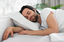 Closeup Of Young Man Sleeping In Bed At Home