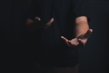 Male empty hand open a palm up on a dark background.