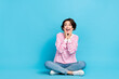 © deagreez - Portrait of impressed astonished girl sitting floor see huge bargain on black friday isolated on blue color background