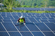 © EmmaStock - Cleaning solar panels by workers in uniform safety at solar farm