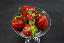 Sweet Strawberries In A Cup On A Leg Close-up