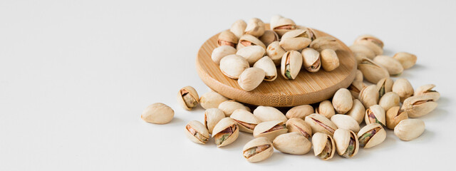 Wall Mural - Heap of pistachios isolated on white background. Overhead