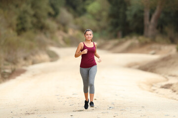 Full body of runner running towards you