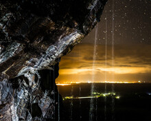 Waterfall Against The Nighttime Lights Of The Sunshine Coast