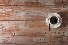 Coffee Cup With Saucer And Spoon On Vintage Wood Surface. Copy Space. Selective Focus.