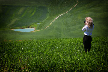 Poster - Young blonde woman taking landscape photographs in Tuscany, Italy, Europe