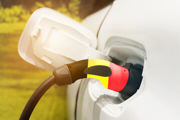 Charging an electric vehicle using an electric cable with the image of the Belgian flag