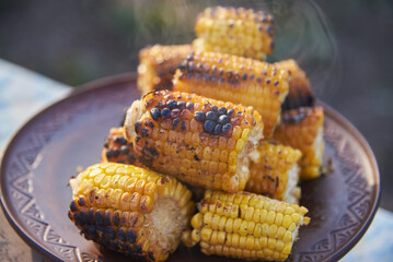 Hot corn cobs baked on the grill.