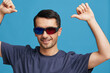 © SHOTPRIME STUDIO - man in blue t-shirt 3d glasses entertainment gesture with hands blue background