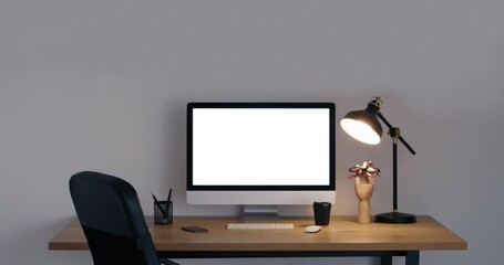 Workplace with modern computer near grey wall