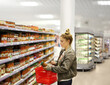 © lado2016 - Woman choosing a dairy products at supermarket