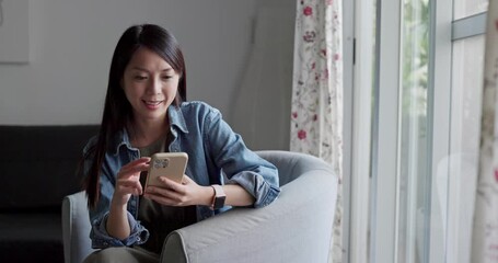 Wall Mural - Woman use mobile phone at home