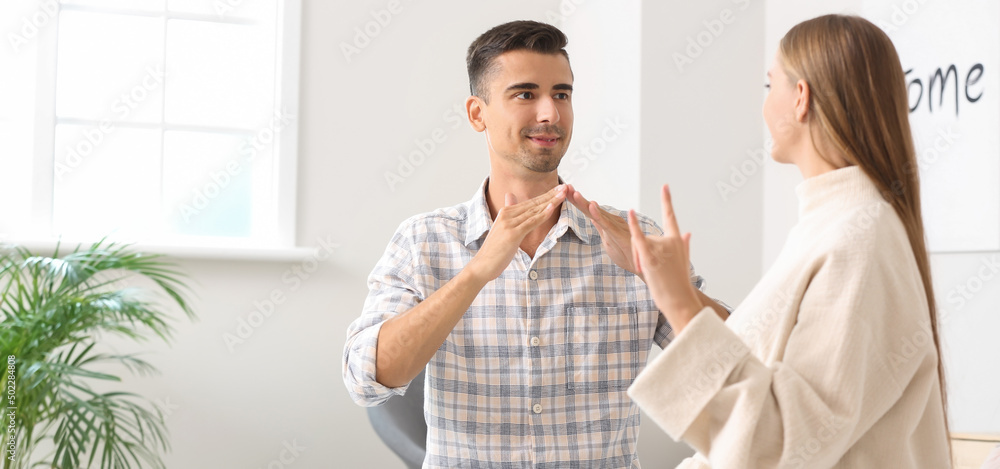 Young deaf mute couple using sign language at home Stock Photo | Adobe ...