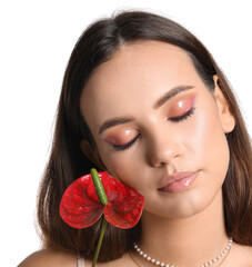 Wall Mural - Woman with closed eyes holding anthurium flower on white background