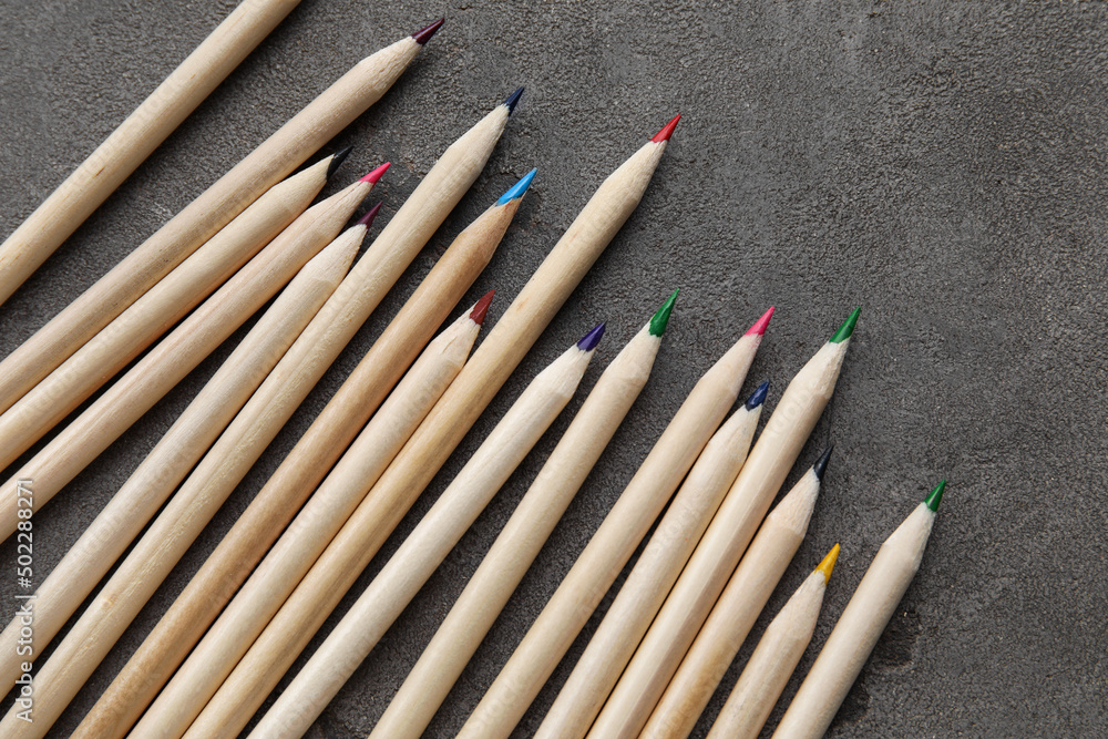 Colorful pencils on dark grunge background