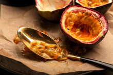 Spoon With Passion Fruit Pulp On Wooden Background
