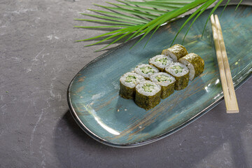 Wall Mural - Mini sushi with vegetables and fish with garnish