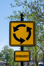 Yellow And Black Roundabout Traffic Sign