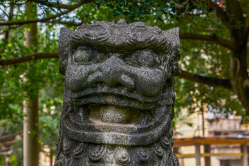 Close-up of an old stone lion in a traditional Chinese garden