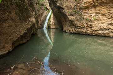 Wall Mural - Small beautiful waterfall in the mountains