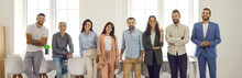 Banner With Group Portrait Of Happy Successful Young And Mature People At Work. Team Of Corporate Employees, Coworkers And Business Professionals Standing In Office, Smiling And Looking At Camera