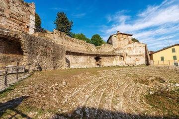 Wall Mural - Old Ruins of the Roman Theatre or Amphitheater in Brescia downtown near the Capitolium Roman Temple (Tempio Capitolino), 1th century AC, UNESCO world heritage site, Lombardy, Italy, Europe.