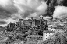 Black And White View Of Bardi Castle, Parma, Italy, Under A Dramatic Sky