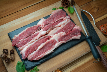 Canvas Print - Fresh Sliced brisket beef on black plate, Sliced brisket beef on wooden background.  