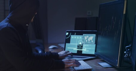 Hacker does digital machinations on online stock exchange in office side view. Cyber criminal attacks global companies financial actives