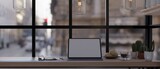 Fototapeta Kawa jest smaczna - Workspace in a offee shop with tablet mockup on table against the window with the city street view