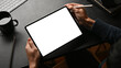© bongkarn - A male graphic designer using his modern digital tablet touchpad at workspace.