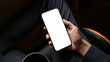© bongkarn - Businessman using his cellphone at his desk. Phone white screen mockup.