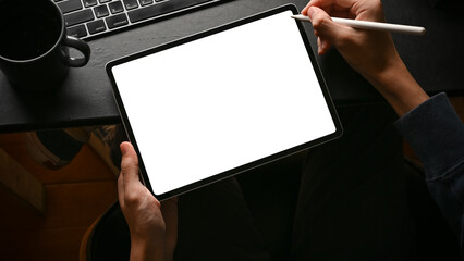 Wall Mural - a man using digital tablet touchpad at his modern office desk.