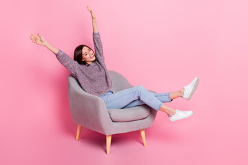 Wall Mural - photo of adorable shiny lady dressed sweater sitting chair riding arms isolated pink color backgroun