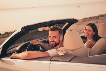 Sticker - Photo of good mood charming wife husband wear casual clothes driving cabriolet smiling outdoors nature beach