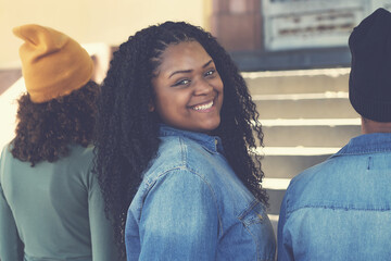 Laughing african american female young adult with group of friends