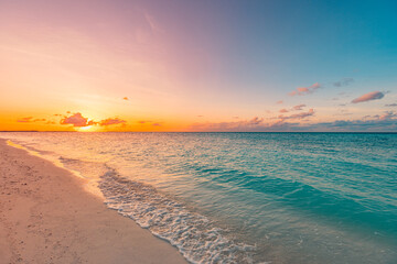 Closeup sea sand beach. Panoramic beach landscape. Inspire tropical beach seascape horizon. Orange and golden sunset sky calmness tranquil relaxing sunlight summer mood. Vacation travel holiday banner