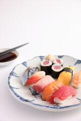 Wall Mural - Sushi Set nigiri and sushi rolls with soy sauce and chopsticks Japanese food isolated in white background