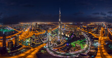Panoramic Aerial View Of Burj Khalifa Skyscraper And Dubai Skyline At Night, United Arab Emirates.