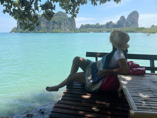 woman sitting and looking to the blue sea view at summer beach.