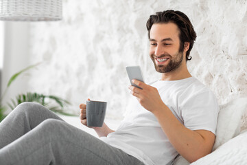 relaxed bearded guy chilling on bed at home