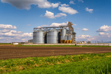 Wall Mural - panorama view on agro silos granary elevator on agro-processing manufacturing plant for processing drying cleaning and storage of agricultural products, flour, cereals and grain.