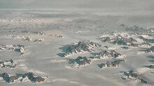 Magnificent Aerial Shot Of High, Foggy Mountains Partly Covered In Snow And Ice