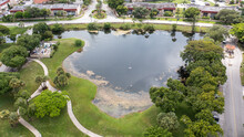 Aerial View Of A Reflective Pond In A Residential Complex In Florida On A Sunny Day