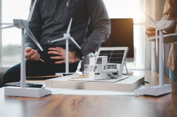 Two engineer design professionals discussion about calculate to use pure energy nature and Installing solar panels on roof house to generate electricity working with model, and Solar panel sample