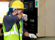 © atitaph - Male engineer wearing a control safety helmet Planning for the maintenance of metal machinery in industrial plants