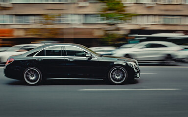 Sticker - Scenic view of a black modern car on the road