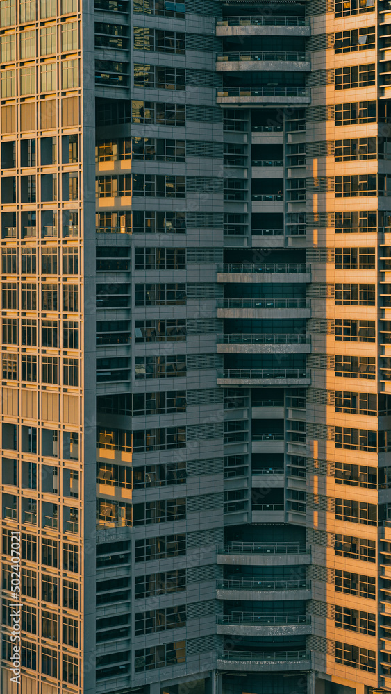 Facade of a modern high-rise building with glass windows under the ...
