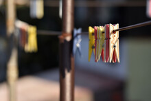 Selective Focus Shot Of Colored Clothespins On A Rope On A Sunny Day