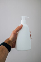 Closeup Shot Of The White Washing Soap Bottle In A Man's Hand